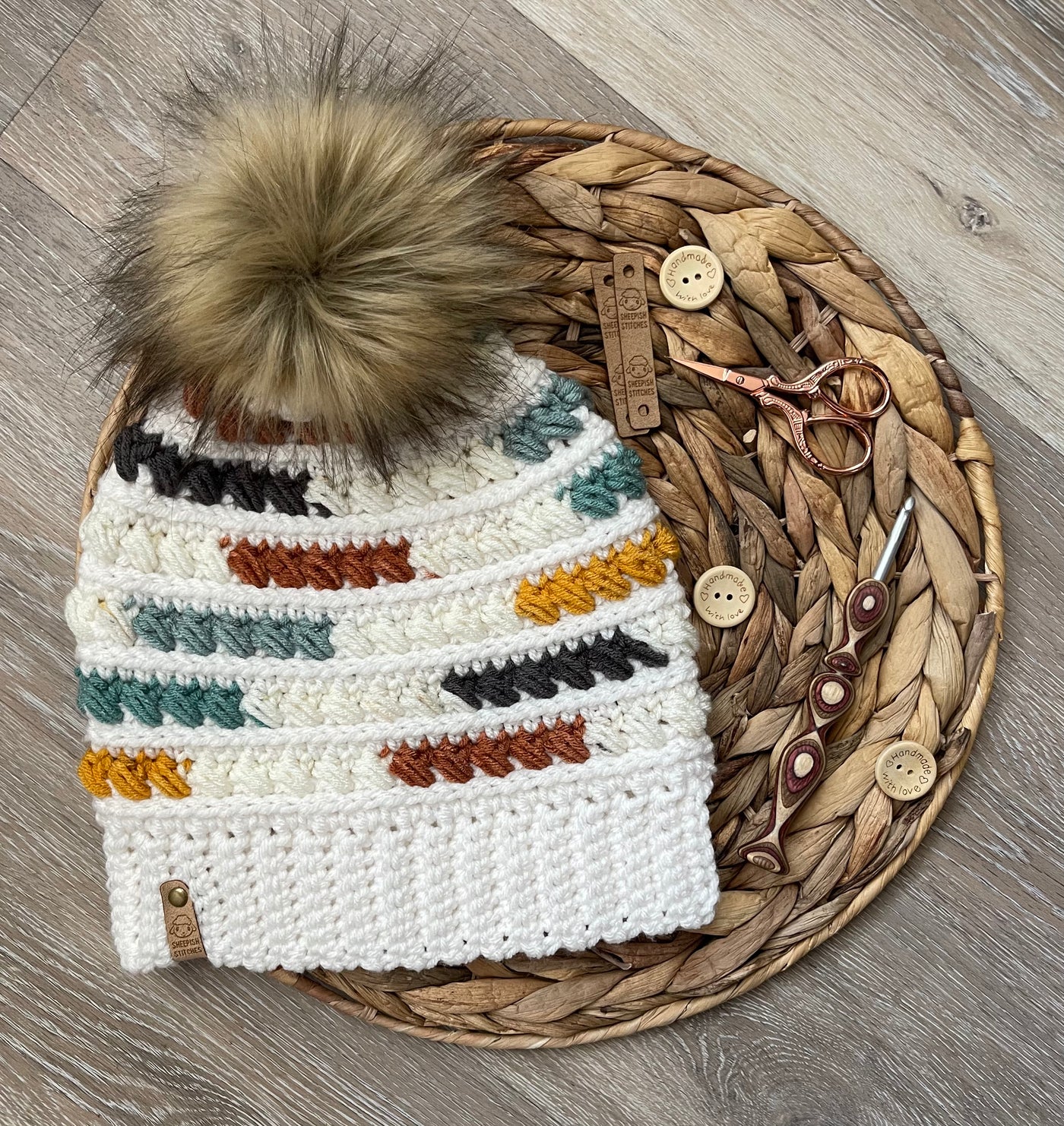 White, Teal, Yellow, Black Multi-Colored Crocheted Beanie with faux fur pom pom